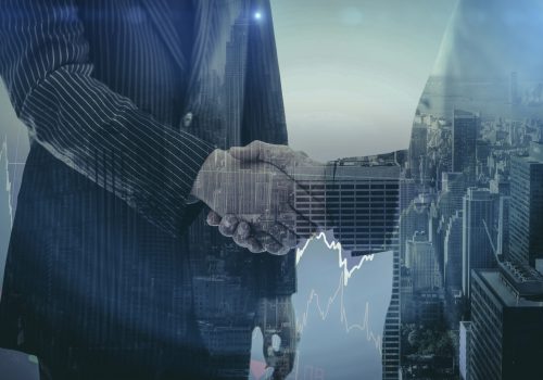 Stocks and shares against composite image of business people shaking hands Stocks and shares against composite image of business people shaking hands
